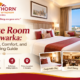 "Spacious deluxe room in Dwarka with king bed, work desk, and seating area at Hawthorn Dwarka"